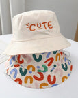 - Reversible Cotton Bucket Hat – “Cute” Print Baby Stork