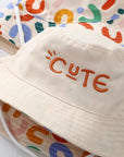 - Reversible Cotton Bucket Hat – “Cute” Print Baby Stork
