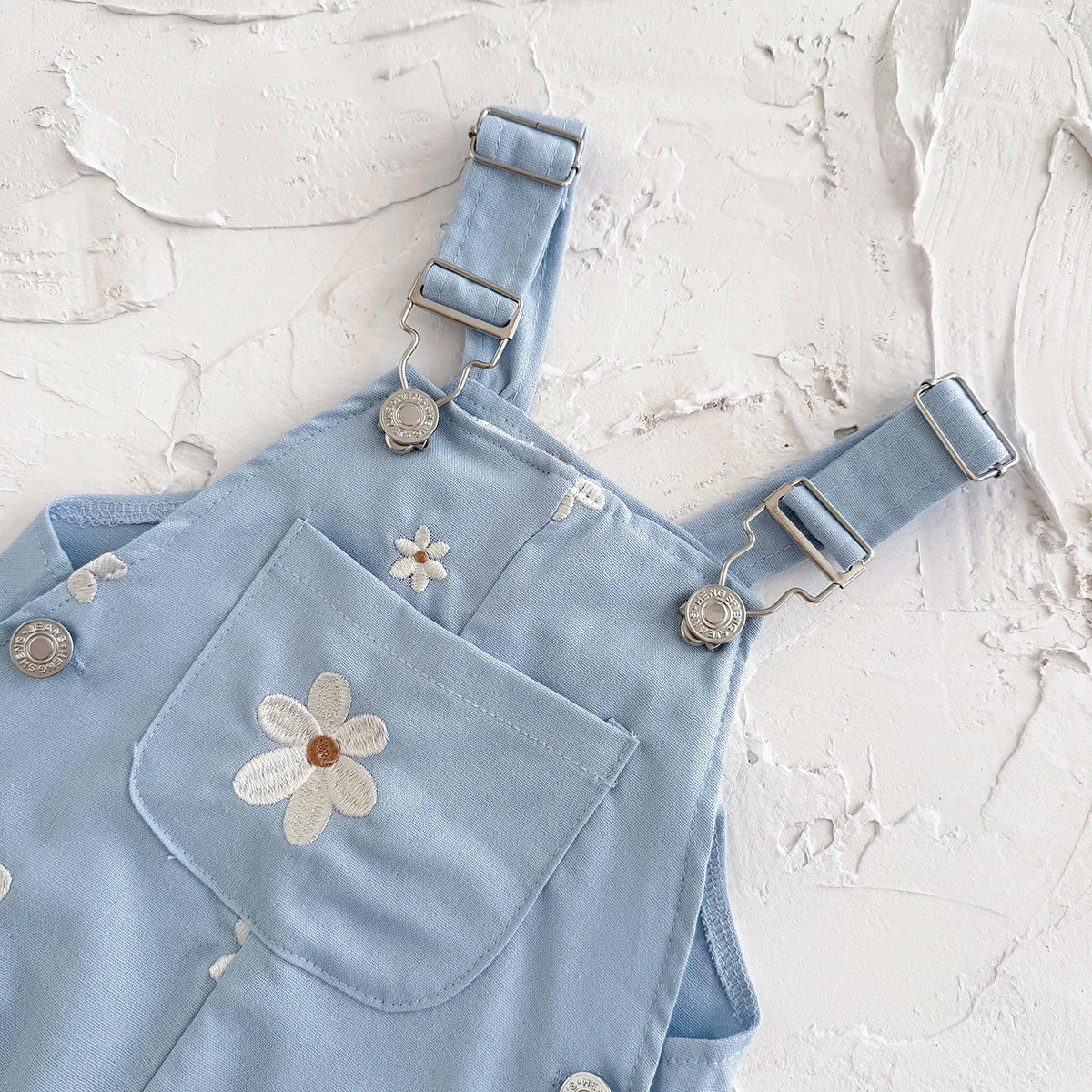 - Daisy Embroidered Overalls – Soft Blue Cotton Baby Stork