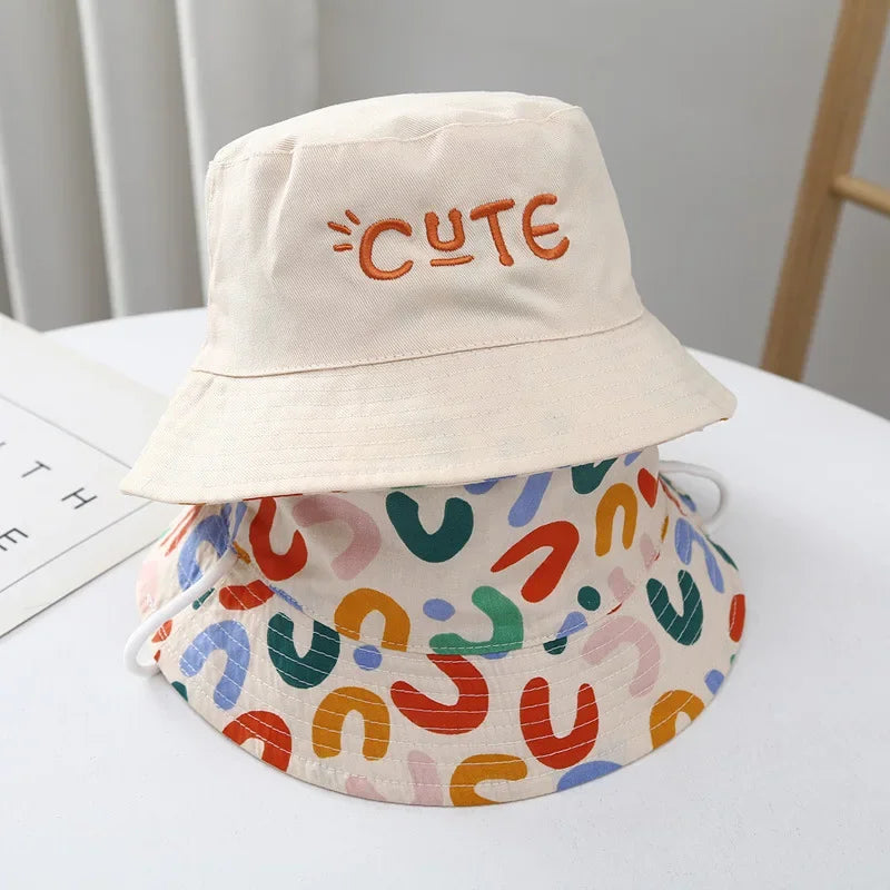 - Reversible Cotton Bucket Hat – “Cute” Print Baby Stork