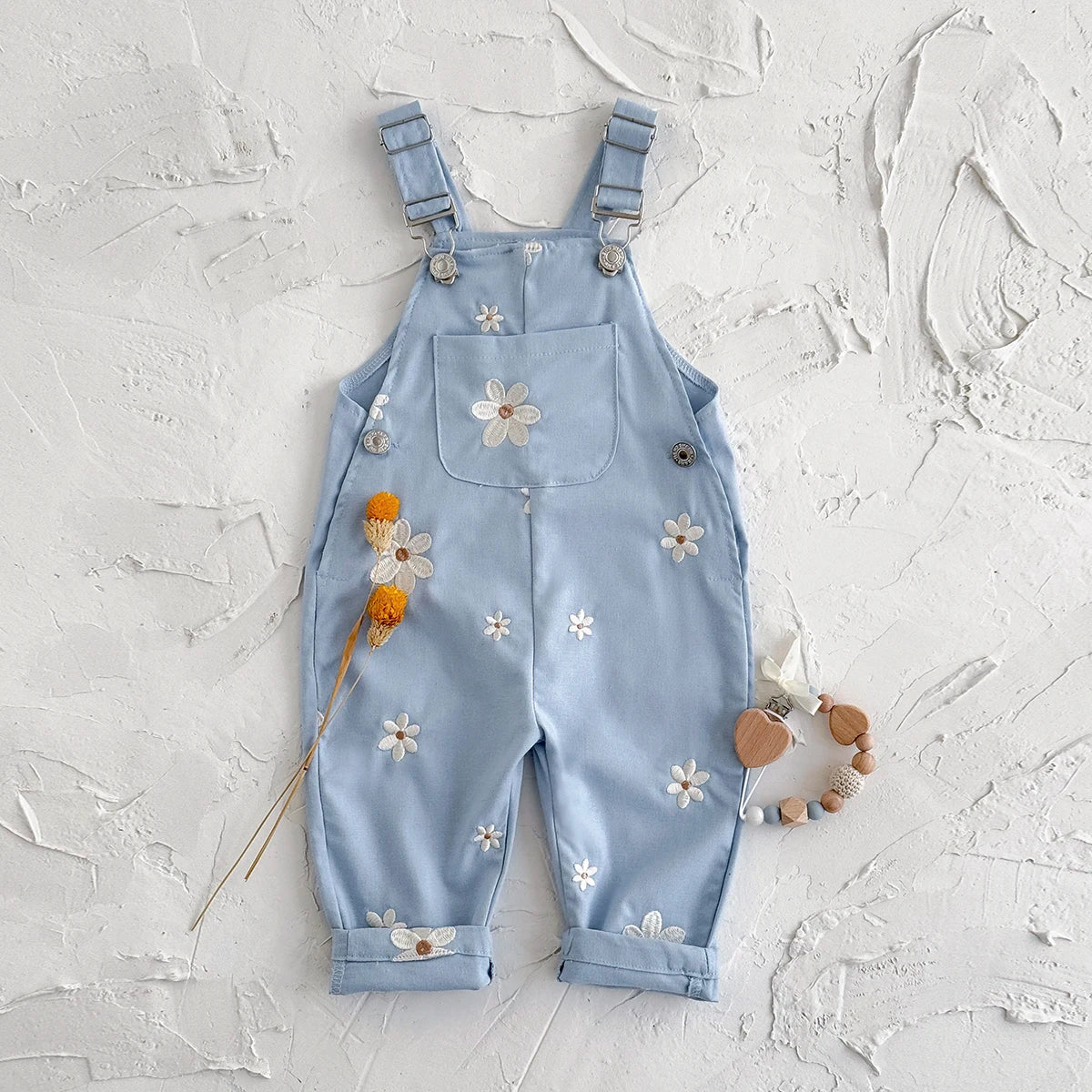 - Daisy Embroidered Overalls – Soft Blue Cotton Baby Stork