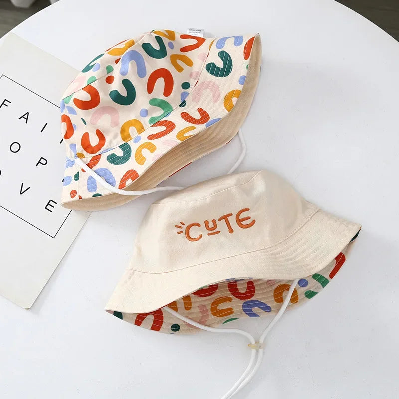 - Reversible Cotton Bucket Hat – “Cute” Print Baby Stork
