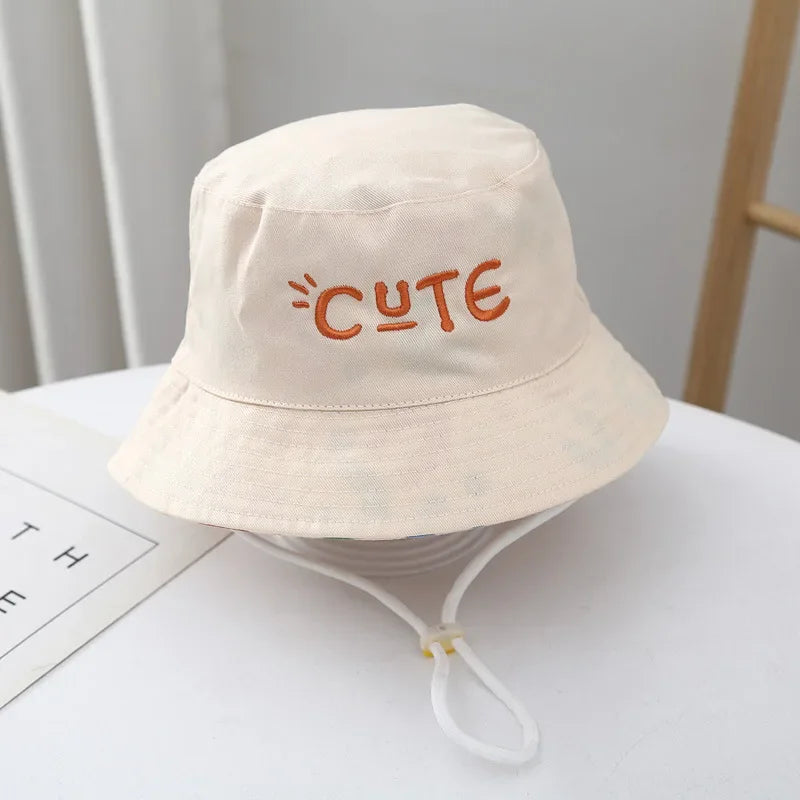 - Reversible Cotton Bucket Hat – “Cute” Print Baby Stork