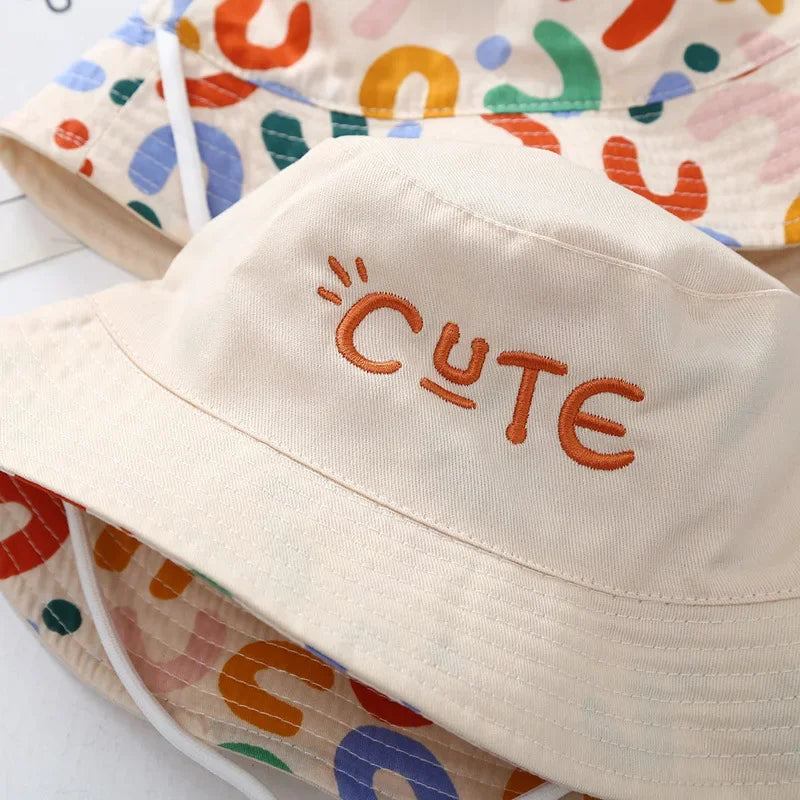 - Reversible Cotton Bucket Hat – “Cute” Print Baby Stork