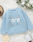 - Baby “One” Knit Birthday Sweater Baby Stork