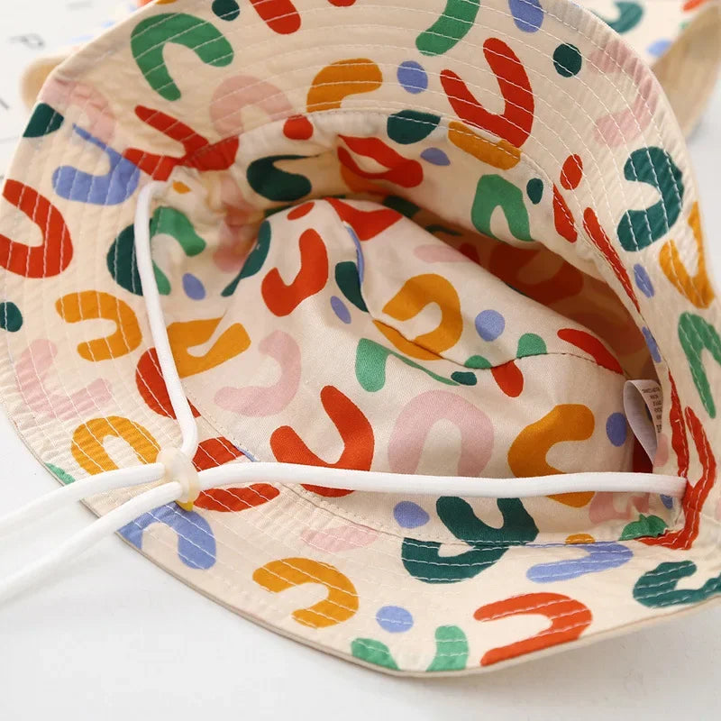 - Reversible Cotton Bucket Hat – “Cute” Print Baby Stork