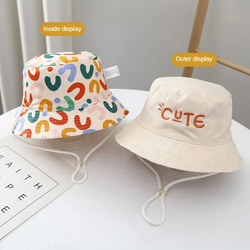 - Reversible Cotton Bucket Hat – “Cute” Print Baby Stork